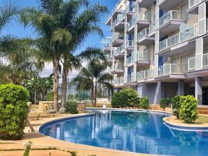a swimming pool in front of a building at The Apartment Olivia in Moncófar