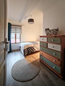 a bedroom with a dresser and a bed in it at Fabrice et Frédérique in Carvin