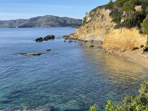 a view of a body of water with a beach at Colibrì by SolturElba in Capoliveri