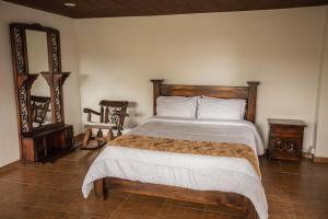 Hotel Campestre La Posada Del Rancho客房内的一张或多张床位