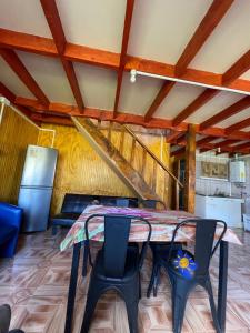 a dining room with a table and chairs at Cabaña la percha in Coihaique