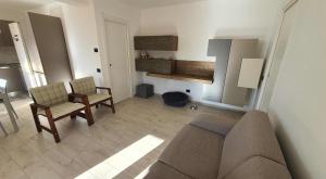 a living room with a couch and two chairs at Bedrock in Salerno