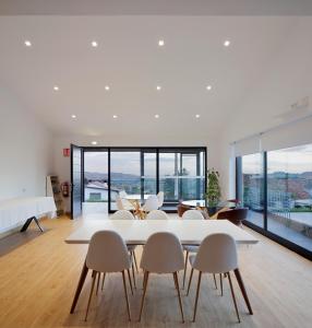 a living room with a white table and chairs at Balcón de Gijón Apartamentos Boutique in Gijón