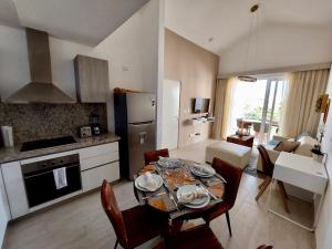 a kitchen and living room with a table and chairs at Unique Pool & Golf view retreat 1BR in Hard Rock in Punta Cana