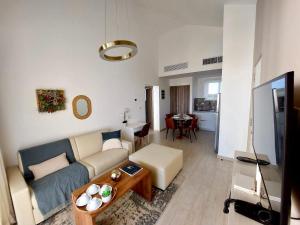 a living room with a couch and a table at Unique Pool & Golf view retreat 1BR in Hard Rock in Punta Cana