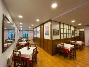 a restaurant with tables and chairs in a room at Hostal Can Josep in Sort