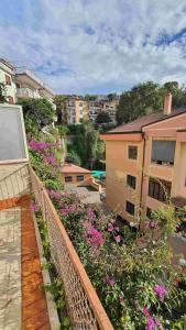 a balcony with pink flowers and a building at Bedrock in Salerno +7 photos