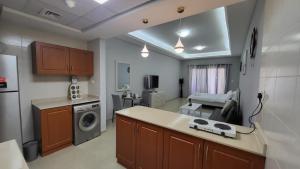 a kitchen with a washer and dryer in a room at Amazing Sea View Flat On The Beach in Ras al Khaimah