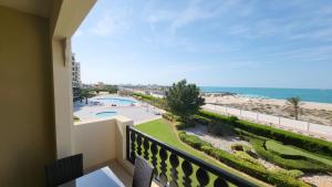 a balcony with a view of the beach and the ocean at Amazing Sea View Flat On The Beach in Ras al Khaimah