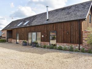 a barn with a building with a garage at The Workshop in Ferndown