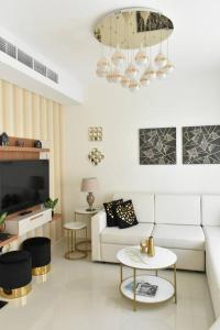 a living room with a couch and a tv at Exquisite Home with Smart Office in Dubai