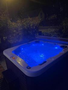 a bath tub with blue water at night at Holiday Home Lupita 1 in Cerje