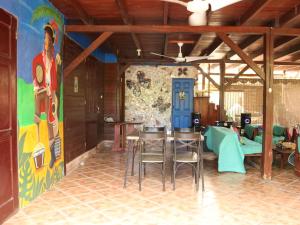 a room with chairs and a wall with a mural at Pirate and Mermaid Beach House in Puerto Viejo