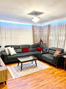 a living room with a black leather couch at Bigger house in Beylikduzu in Buyukcekmece