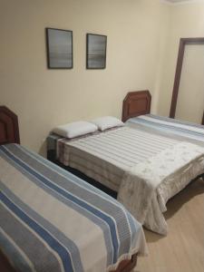 Łóżko lub łóżka w pokoju w obiekcie Casarão Primavera