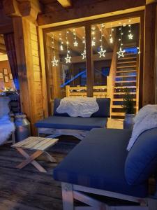 a living room with blue couches and christmas lights at Chalet de montagne style savoyard, vue sur pistes in Châtel