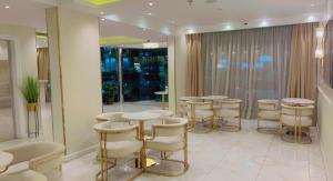 a room with a row of stools and tables at Ghima Jeddah in Jeddah