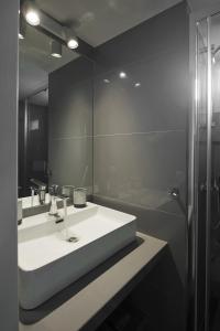 a bathroom with a sink and a shower and a mirror at LucyZen in Athens