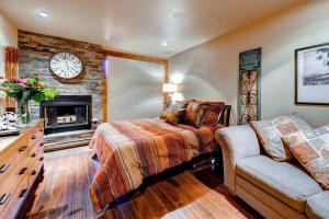 a bedroom with a bed and a fireplace at Studio Condo 318 in Historic Frisco at Cedars Lodge in Frisco