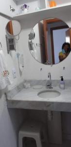 uma casa de banho com um lavatório e um espelho em VOG Torres do Sul Ilhéus em Ilhéus