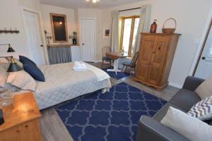 ein Schlafzimmer mit einem Bett und einem blauen Teppich in der Unterkunft Chez Les Bergeron in Saint Aime Des Lacs