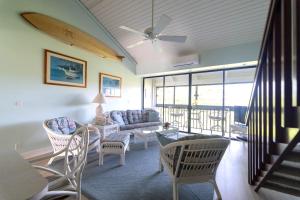 a living room with a couch and a table and chairs at NorthShore Haven Condo in Kahuku