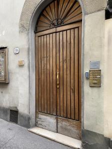 una puerta de madera en el lateral de un edificio en Acacia Firenze - Gelsomino, en Florencia