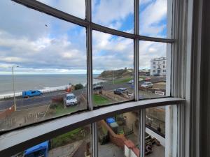 a view of the ocean from a window at Sea View flat 2 with Fast WiFi and FREE parking in Scarborough