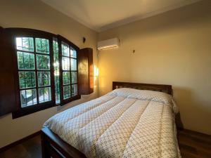 a bedroom with a bed and two windows at Arrea Mutillak in Goya