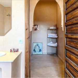 a bathroom with a sink and a towel rack at Jenan Mayshad Marrakech, Boutique hotel with Pool & Private Padel Court in Marrakech