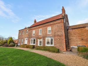 a large brick building with a yard in front of it at Manor House in York