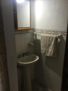 a bathroom with a sink and a mirror and a towel at La Rosada in La Paloma