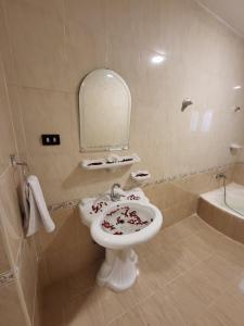 a bathroom with a white sink and a mirror at Lucky Pyramids View in Cairo +37 photos