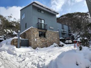 a building with snow in front of it at Snowcreek 2 Alpine Chalet, Private Garage in Thredbo
