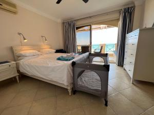 a bedroom with a bed with a view of the ocean at Amazing Beachfront townhouse chalet Ain Sokhna LaVista 1 in Ain Sokhna