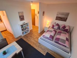 a bedroom with a large bed and a living room at Apartment Salinenpromenade Bad Kissingen in Bad Kissingen