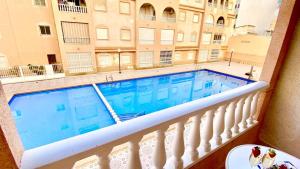 a swimming pool on the balcony of a building at Apartamento Mimosa in Torrevieja