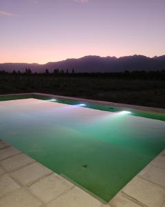 a pool of green water with the mountains in the background at CARASUR in Vista Flores