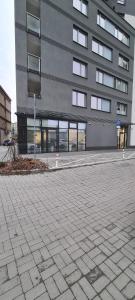 a large building with many windows on a street at Apartament Panoramiczna in Kielce