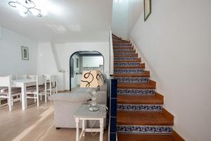 a staircase in a house with a chair and a table at Holiday Beach Varadero in Santa Pola