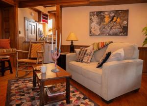 a living room with a couch and a table at Adirondack Mountain View Retreat in Elizabethtown
