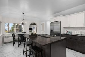 a kitchen with a large island in the middle at Lakefront House by Michigan Waterfront Luxury Properties in Norton Shores