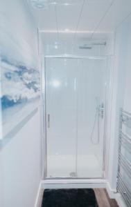 a bathroom with a shower with a glass door at Luxury Modern 3 Bedroom Apartment in City Centre in Edinburgh +115 photos