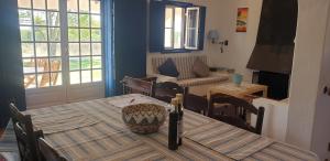 a living room with a table and chairs and a couch at Sondela Self Catering in São Martinho do Porto