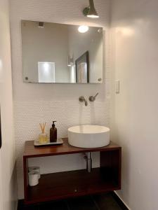a bathroom with a sink and a mirror at [RARE] Buckhead Mid-century Masterpiece! in Atlanta