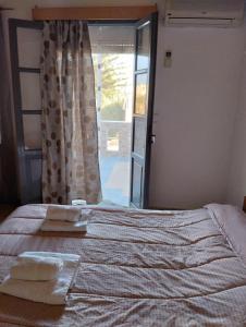 a bedroom with a bed with two towels on it at Villas Irene 3 Family Apartments in Gournes