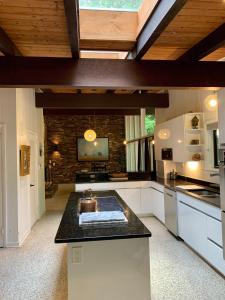 a kitchen with a counter top in a room at [RARE] Buckhead Mid-century Masterpiece! in Atlanta