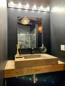 a bathroom with a large sink and a mirror at [RARE] Buckhead Mid-century Masterpiece! in Atlanta