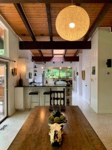 a large kitchen with a wooden table in a room at [RARE] Buckhead Mid-century Masterpiece! in Atlanta