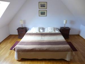a bedroom with a large bed with two night stands at Tulin in Wetlina